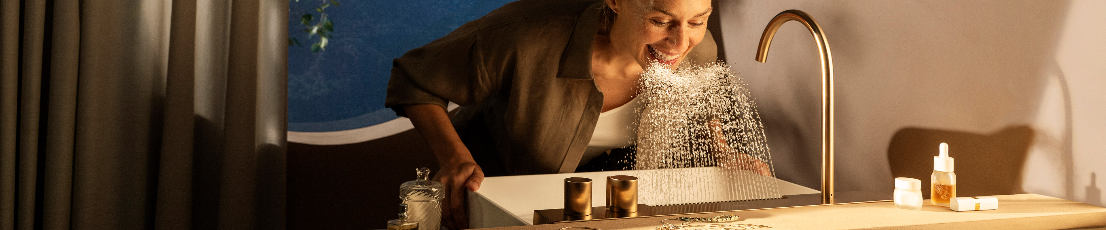 Woman bends over a sprinkling Avalegra AquaUnit.