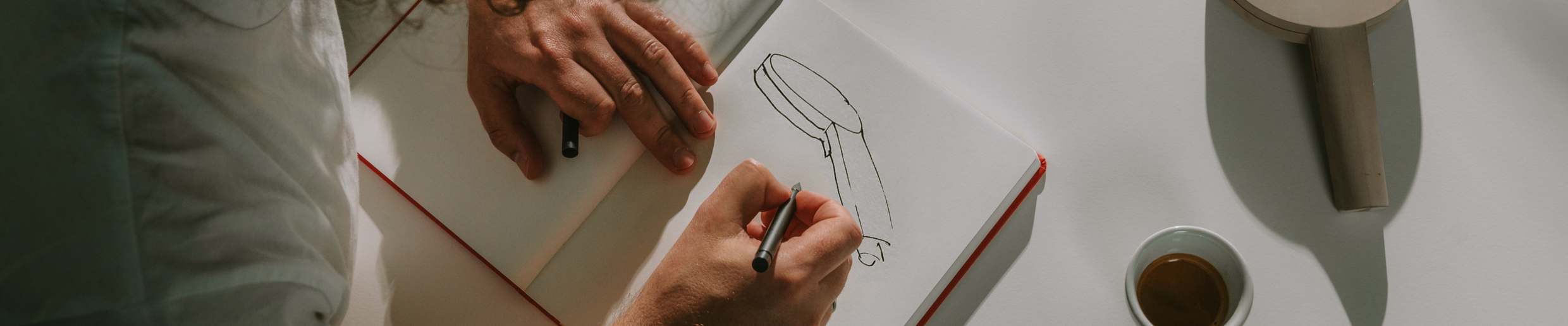 A designer sketching a hansgrohe hand shower.