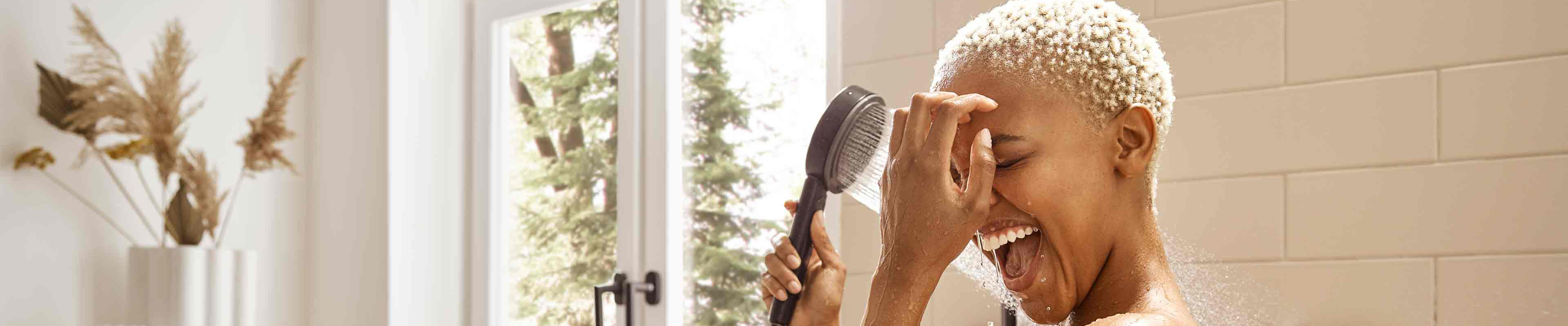 Woman is enthralled by Pulsify overhead shower with PowderRain.