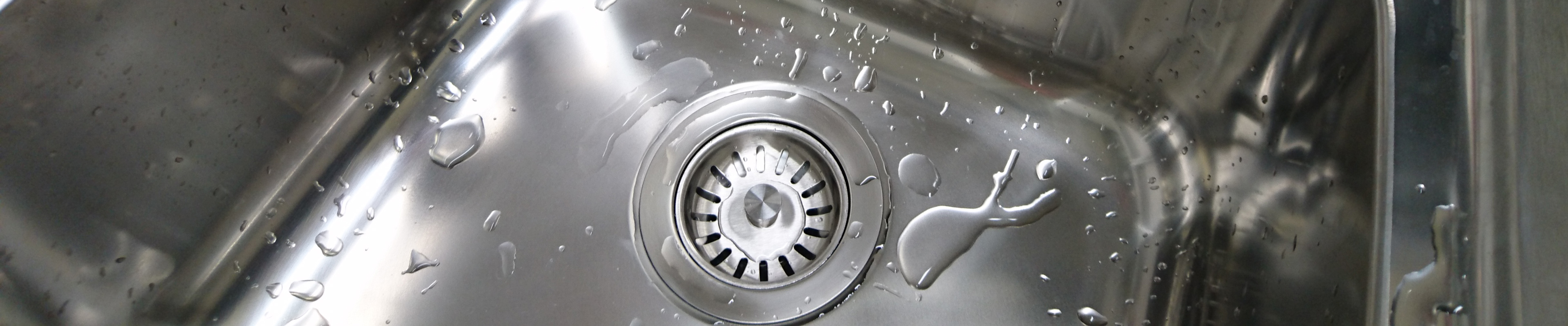 Strainer basket for the drain of a hansgrohe stainless steel sink.